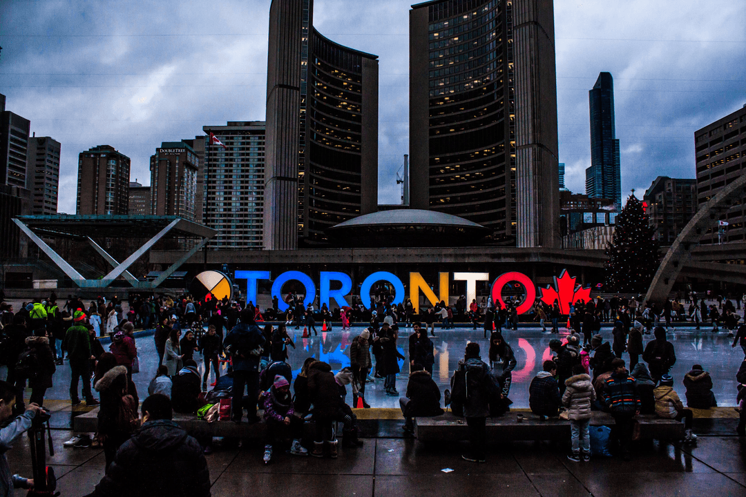 A picture of a gathering in Toronto in the middle of tall buidings