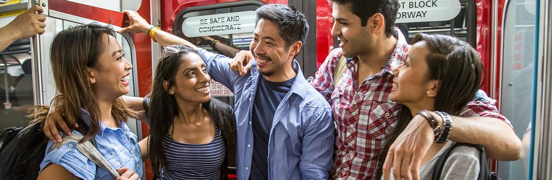A set of male and female friends travelling in metro