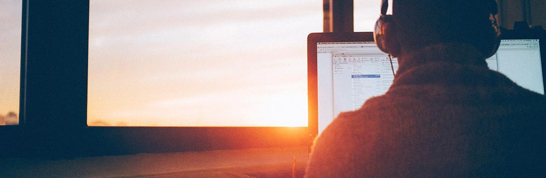 back view of a person looking at laptop