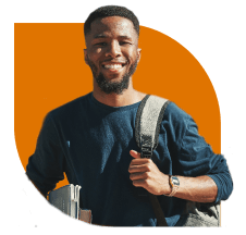 A smiling IDP student holding a laptop.