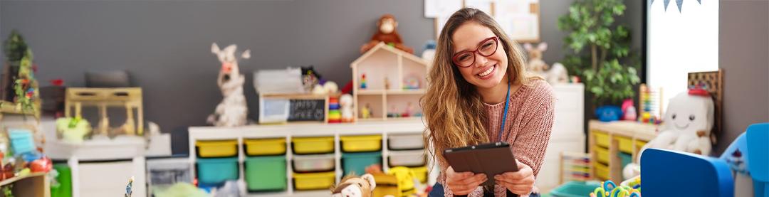 A preschool teacher smiling confident in a classroom