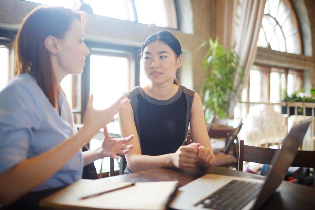Two friends engage in conversation about their application.