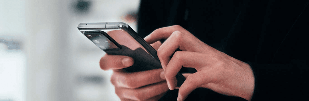 hand holding phone typing