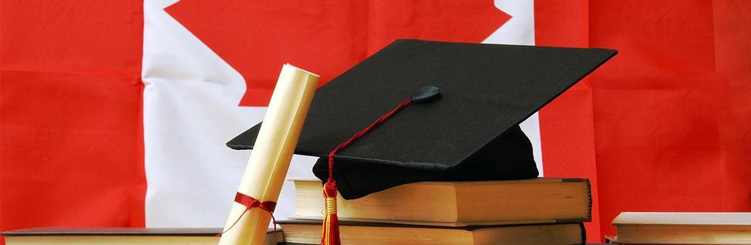 graduation cap and certificate along with a canada flag
