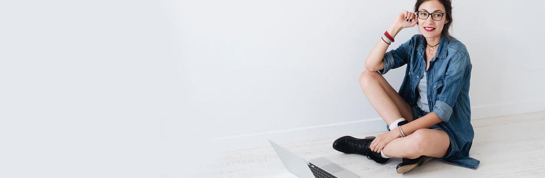 A female student posing for a picture with her laptop
