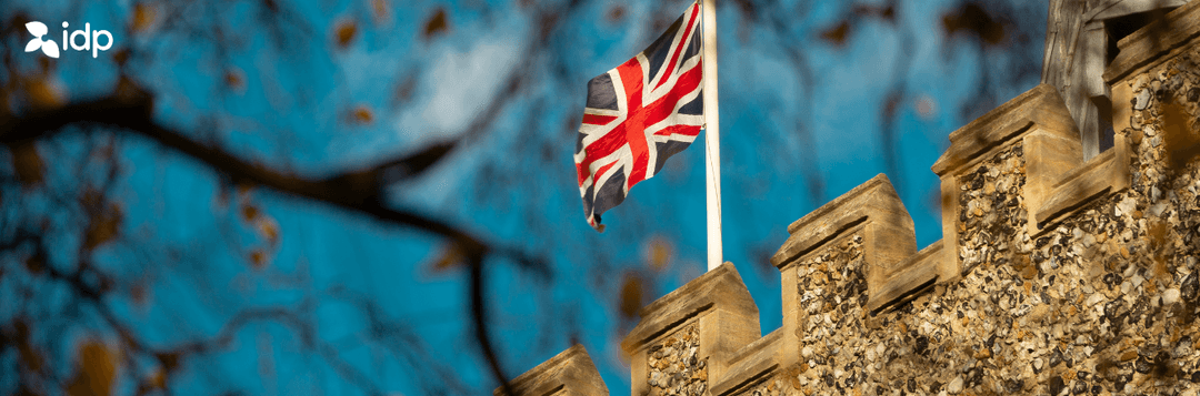 UK flag waving in the air on top of a building