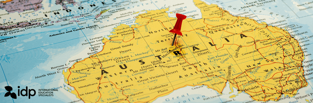 A map of Australia with a red pushpin marking a location in the Northern Territory; the idp International Education Specialists logo appears in the lower left corner.