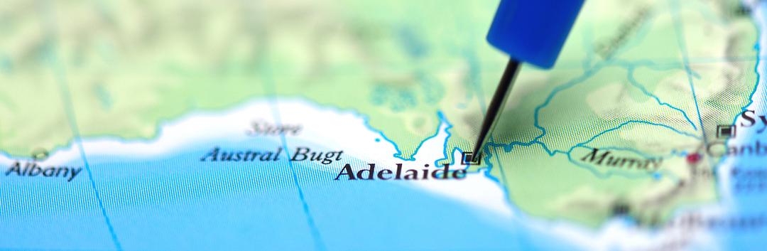 Blue pushpin marking Adelaide on a map of South Australia, showing coastline and surrounding regions