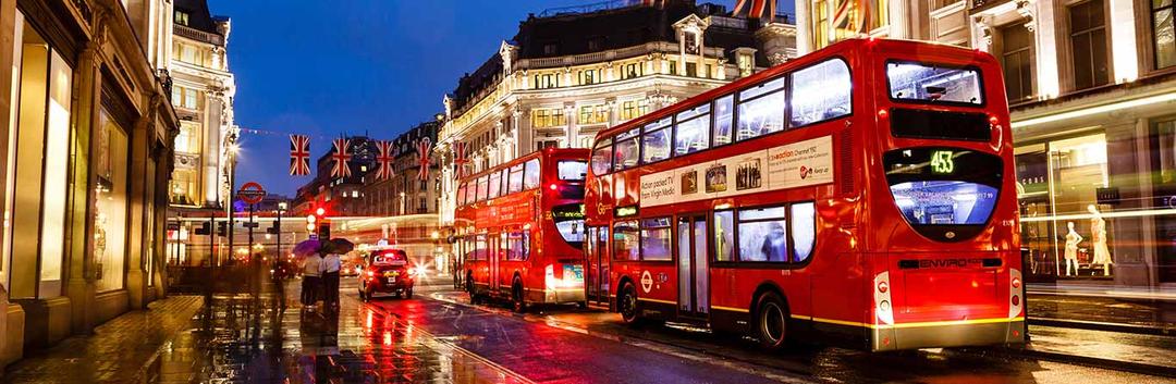 Buses on the city streets of London at night